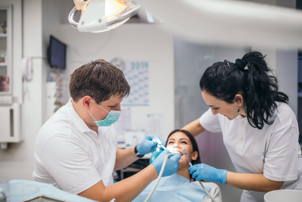 dental assistant helping dentist during patient procedure